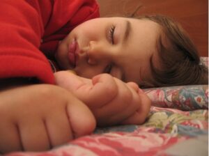 A sleeping child. When we sleep, we dream, but dreams are often influenced by the events of our daily lives.